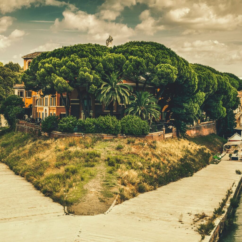 View of Tiber Island in Rome with historic bridges and modern cityscape.